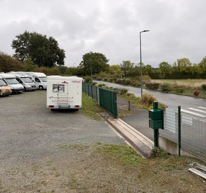 Entrée de l'atelier : portail et parking gravillonné